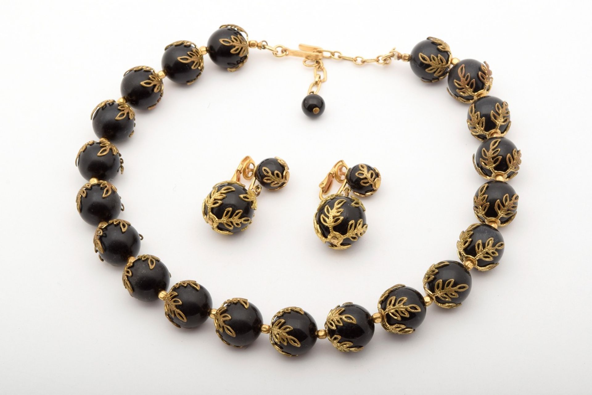 3 pieces gold-plated costume jewellery with black plastic beads, signed "Trifari": 1x necklace (l. 