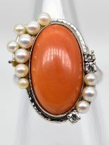 Ring mit Korallen-Cabochon, 11 Perlen und 3 Brillanten, zus. ca. 0,09 ct, 90- er Jahre.