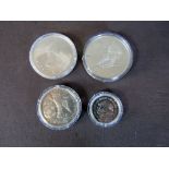 Vier Silbermünzen unter anderem Mexico