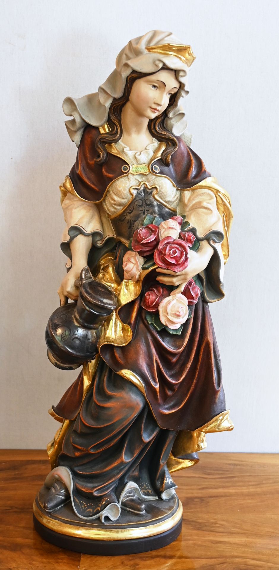 1 Holzfigur am Boden bez. C. NOCKER "Heilige Elisabeth mit Rosen" farbig gefasst, H ca. 80cm, min. b