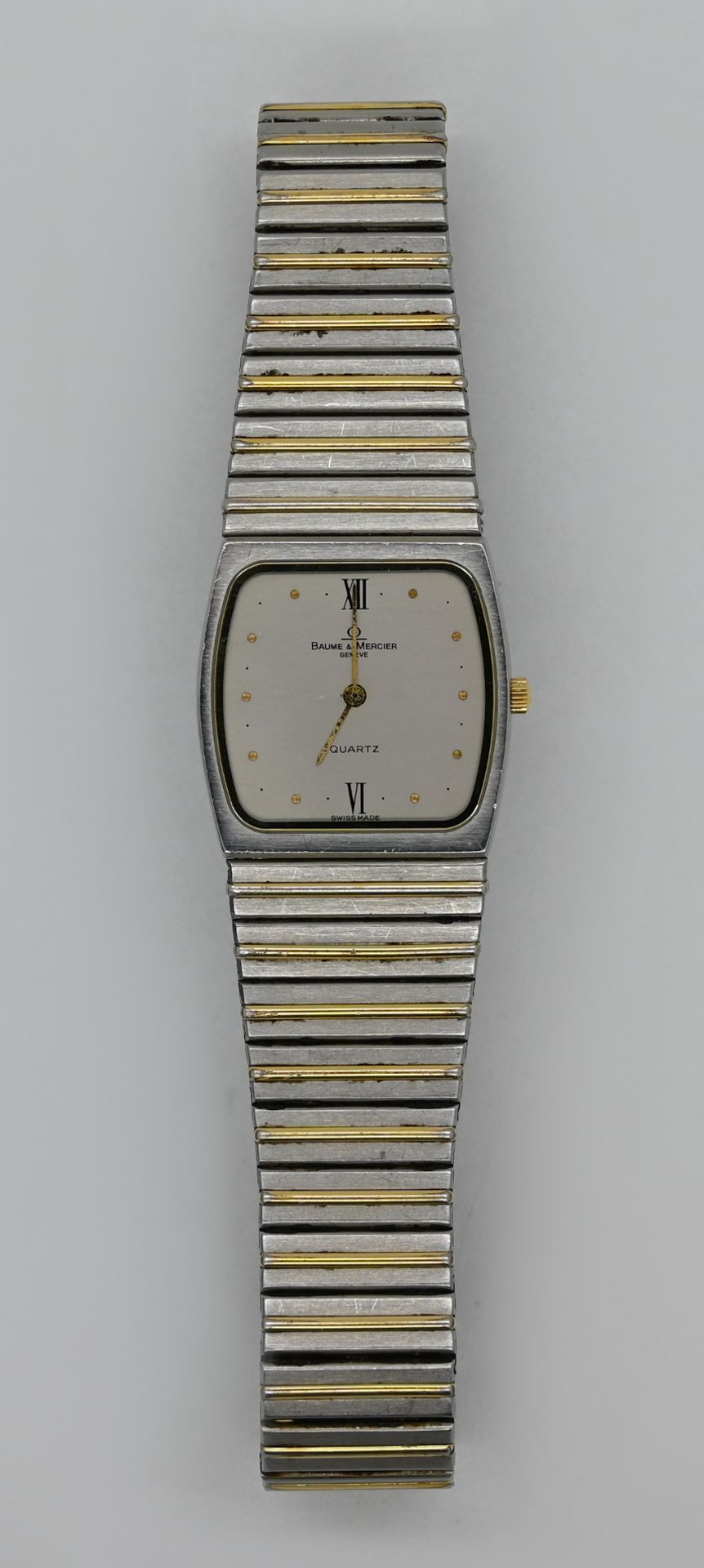 1 Armbanduhr BAUME & MERCIER Quartz., Stahl, wohl z.T. vergoldet mit 2 Ersatzgliedern Tsp.