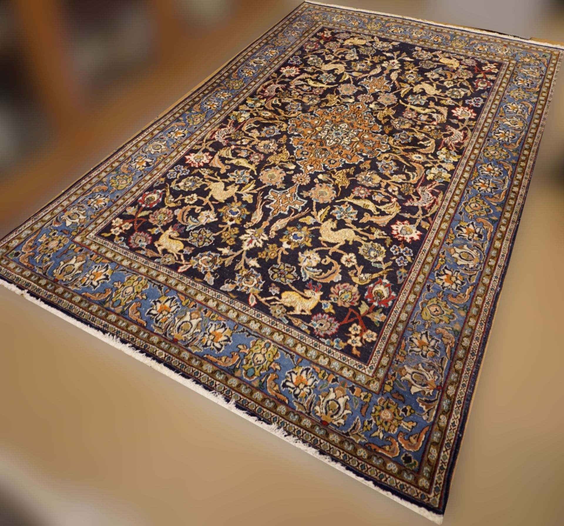 3 Orientteppiche z.T. Iran, GHOM, je dunkelblaugrundig mit floralem Dekor von ca. 168x105cm bis ca.