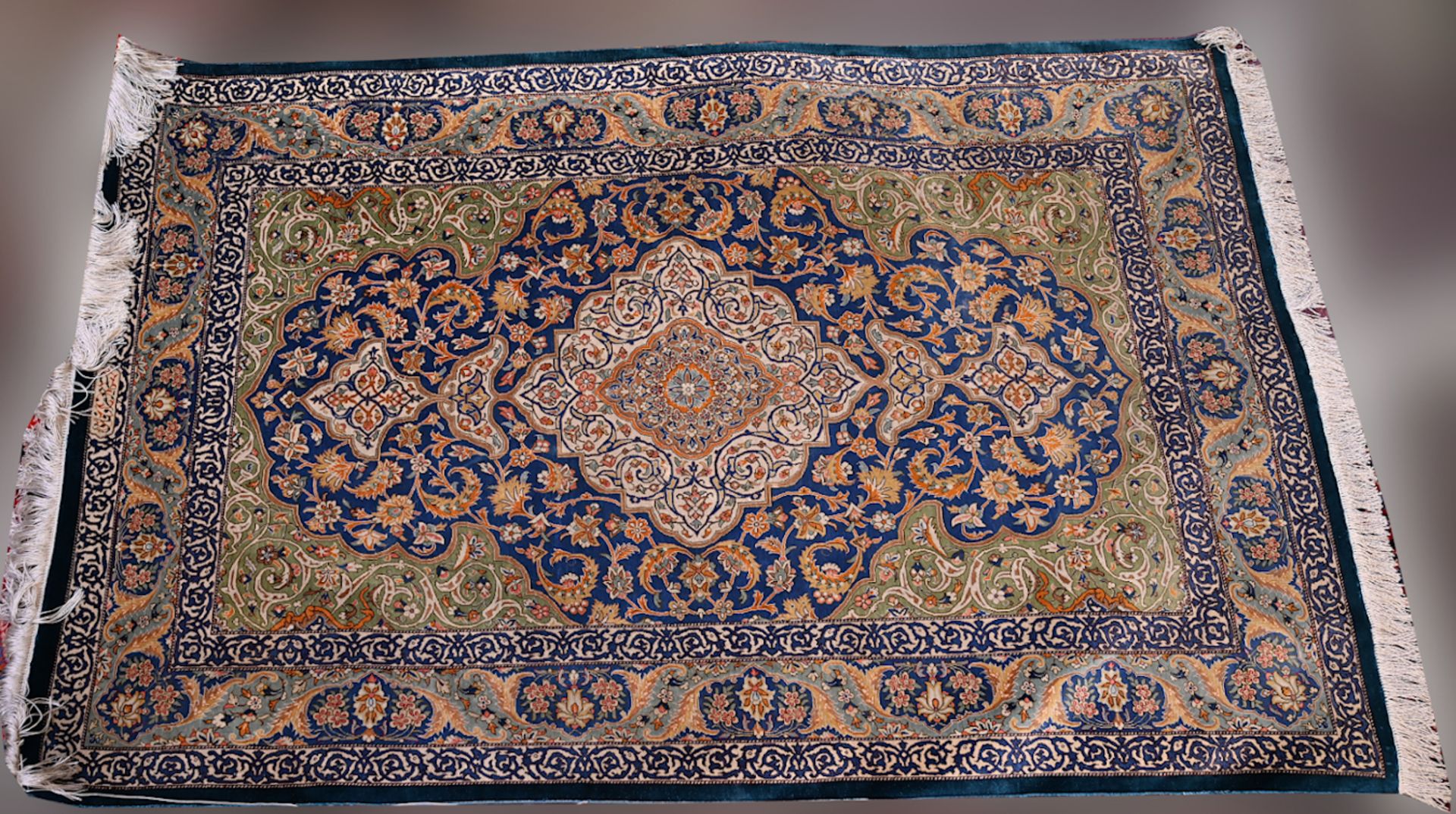 1 Orientteppich Seide 20. Jh. grün-/blaugrundig, signiert, ca. 153x99cm, Fransen, z.T. min. ber., As