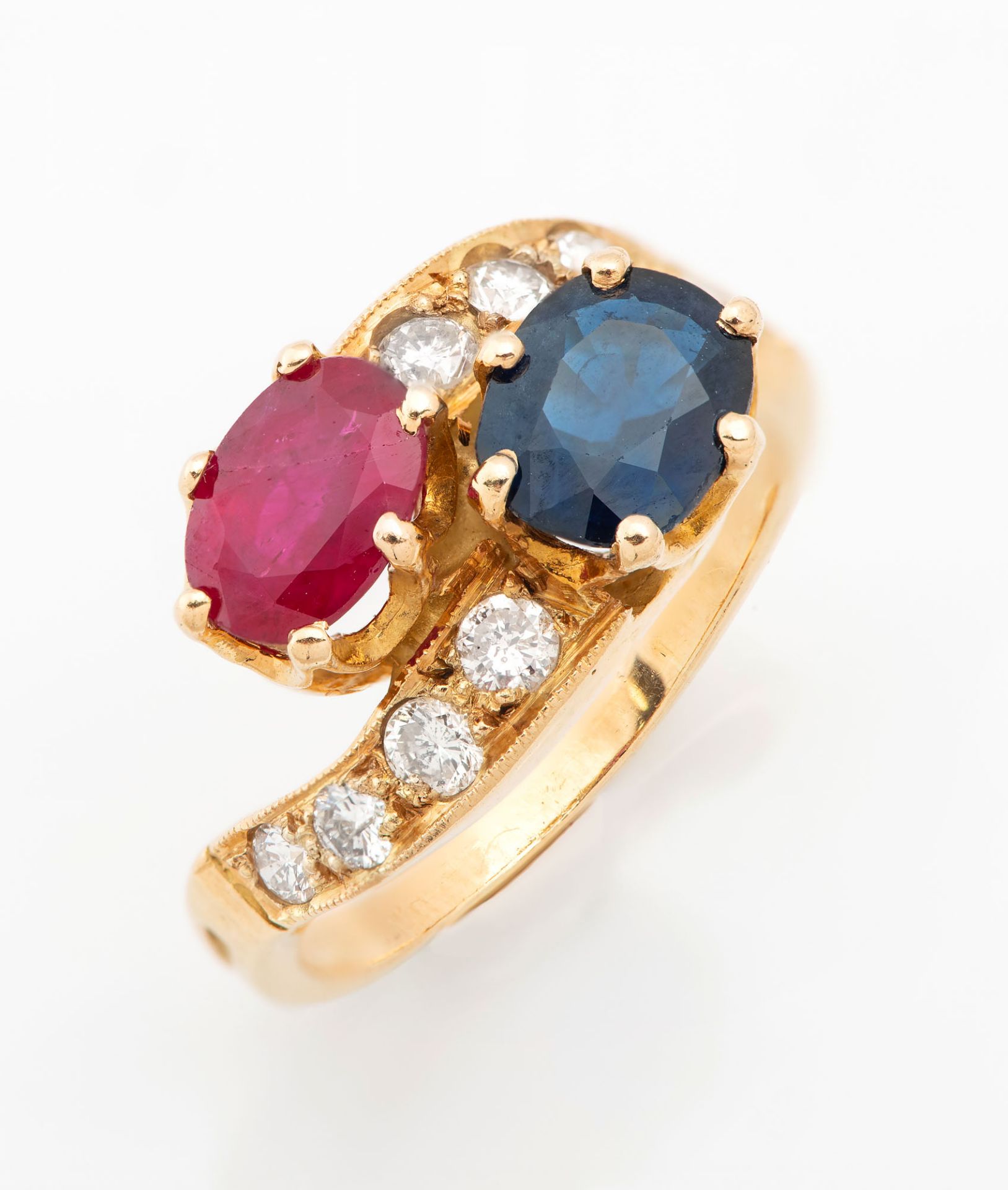 An 18K Gold Diamond Sapphire and Ruby Ring