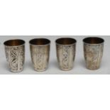 A set of four Russian silver and niello vodka cups, gilt interiors, 5cm high, Soviet marks