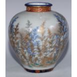 A Japanese Arita porcelain ovoid vase, painted in tones of blue and gilt with a forest, the