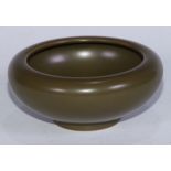 A Chinese monochrome bowl, glazed in tones of green, 14cm diam, seal mark