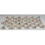 Forty crested ware pigs, standing, each with town crest in polychrome, various markers