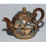 A Japanese Satsuma miniature globular teapot, painted with figures in an interior, 9cm long, seal