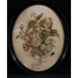 A George III oval needlework picture, embroidered in colour silk threads with a still life of