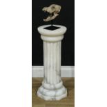 A late 19th century alabaster statuary pedestal, carved as a fluted Doric pillar, octagonal base,