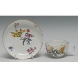 A mid 18th century Meissen cup and saucer, painted with blown tulips and other flowers, small