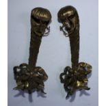 A pair of early 20th century novelty gilt brass wall lights cast as ribbon tied stylised Ostrich