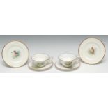 A pair of Royal Worcester teacups, saucers and side plates, painted by D Jones, signed, with