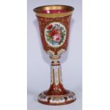 A 19th century Bohemian ruby and white overlay glass goblet, inverted bell shaped bowl painted