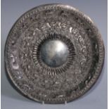 An Indian silver coloured metal salver, embossed with wild animals and scrolls, 25cm diam, c.1900,