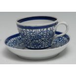 A Worcester Barr period Royal Lily pattern ogee shaped teacup and saucer, with entwined handle, c.