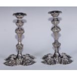 A pair of George II style electro-plated table candlesticks, cast in the manner of Paul de Lamerie