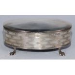 An Edwardian silver oval dressing table box, hinged cover, the side embossedc with bands of fleur