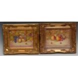 A pair of English porcelain rectangular plaques, painted by Ernest R. Booth, signed, with ripe fruit