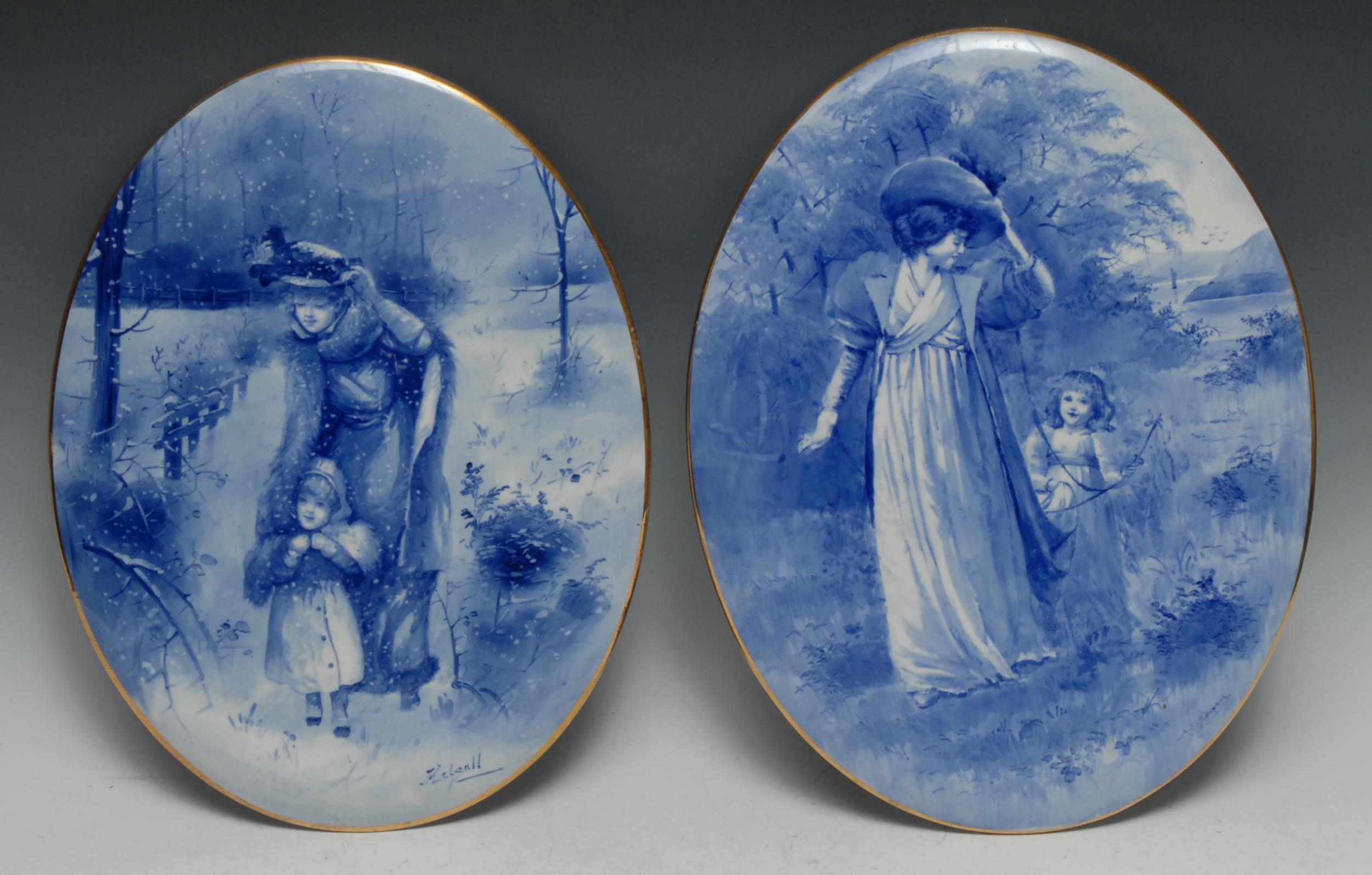 A pair of Doulton Burslem earthenware oval plaques, decorated in underglaze blue with a genre