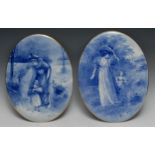 A pair of Doulton Burslem earthenware oval plaques, decorated in underglaze blue with a genre
