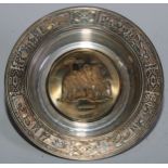 A South African parcel-gilt silver circular dish, the field with a family of elephants, 18.5cm diam,