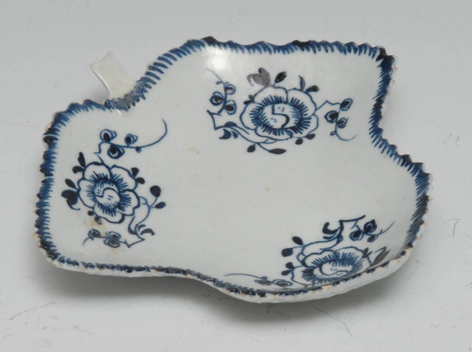 A Liverpool leaf shaped pickle dish, painted with three trailing flowers, the underside in relief,