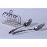 A George V silver seven bar toast rack, arched divisions, 12cm long, Chester 1921, 144g; a pair of