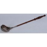 A William IV/early Victorian Scottish silver punch ladle, the bowl chased with stiff leaves, flowers