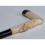 An early 20th century silver coloured metal gentleman's walking stick, the ivory L-shaped handle