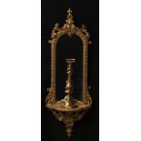 A 19th century giltwood looking glass wall bracket, the arched mirror plate with leafy cresting