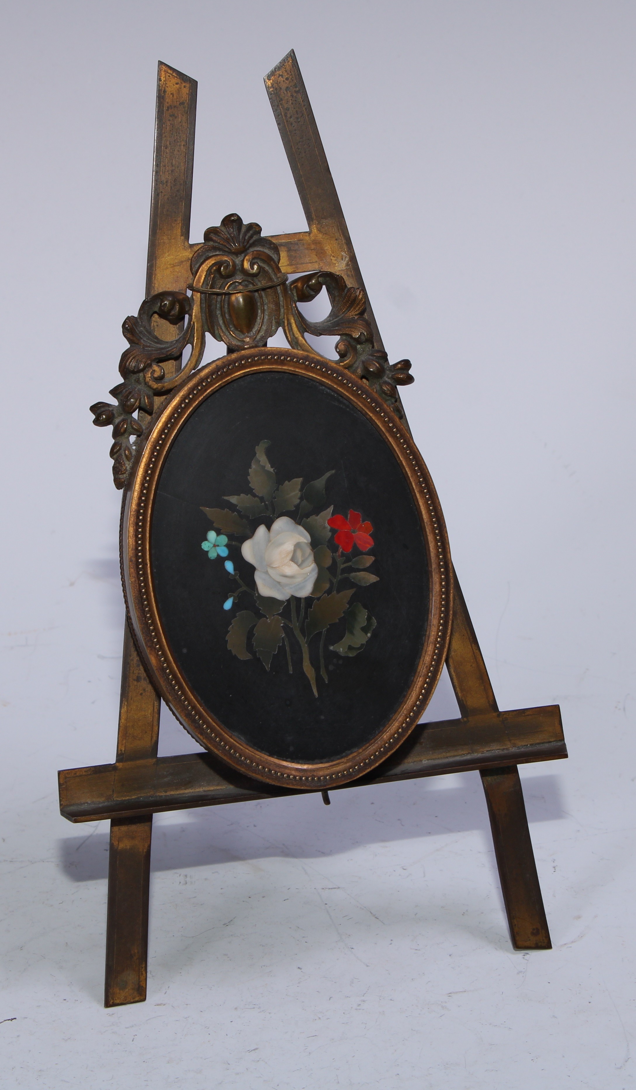 A Florentine pietra dura photograph frame, the hinged oval cover set with a black marble panel