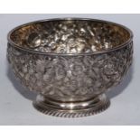 A 19th century American silver circular pedestal bowl, profusely chased with flowers and foliage,