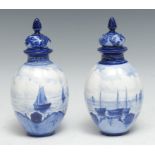 A pair of Royal Crown Derby lobed ovoid vase and covers, painted by W E J Dean, with shipping scenes