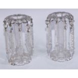 A pair of Victorian clear glass candle lustres, the everted rims raised on knopped faceted stems