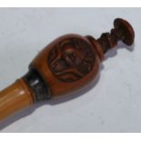 A 19th century Chinese novelty automaton walking stick, the gourd pommel carved with landscape