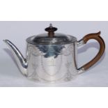 A George III Provincial oval drum teapot, bright-cut engraved with swags, Classical urns and leafy