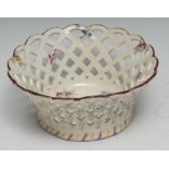 A Bow pierced basket, painted with coloured flowers the exterior with applied flower heads, 17cm