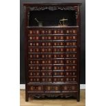 A Chinese hardwood apothecary medicine chest, moulded cornice above an open niche with a pierced