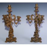 A pair of 19th century gilt metal four-light candelabra, cast with birds, flowers and fruiting vine,