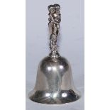 An Edwardian cast silver table bell, the handle with scantily clad putti, 15cm high, Harry