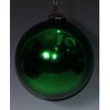 A late 19th/early 20th century iridescent green glass witches ball, metal hanging pendant, 18cm diam