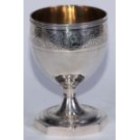 A George III silver pedestal goblet, reeded rim above a wrigglework band of flowering and fruiting