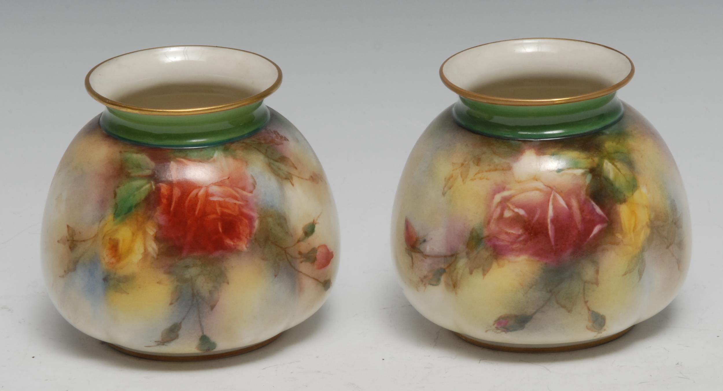 A pair of Hadley Worcester lobed ovoid vases, decorated with red and yellow cabbage roses, 8cm high,