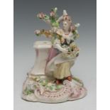 A Chelsea figure, modelled by Joseph Williams, of a lady standing beside a pedestal with a basket of