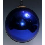 A late 19th/early 20th century iridescent blue glass witches ball, metal hanging pendant, 20cm diam