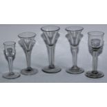 A group of five George III wine glasses, three trumpet shaped, one with folded foot and two with