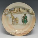 A late 19th century Royal Doulton Dickensware charger, signed Noke, decorated with two Dickensian