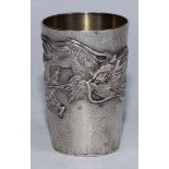 A Japanese silver tapered cylindrical beaker, applied with a ferocious dragon on a planished ground,